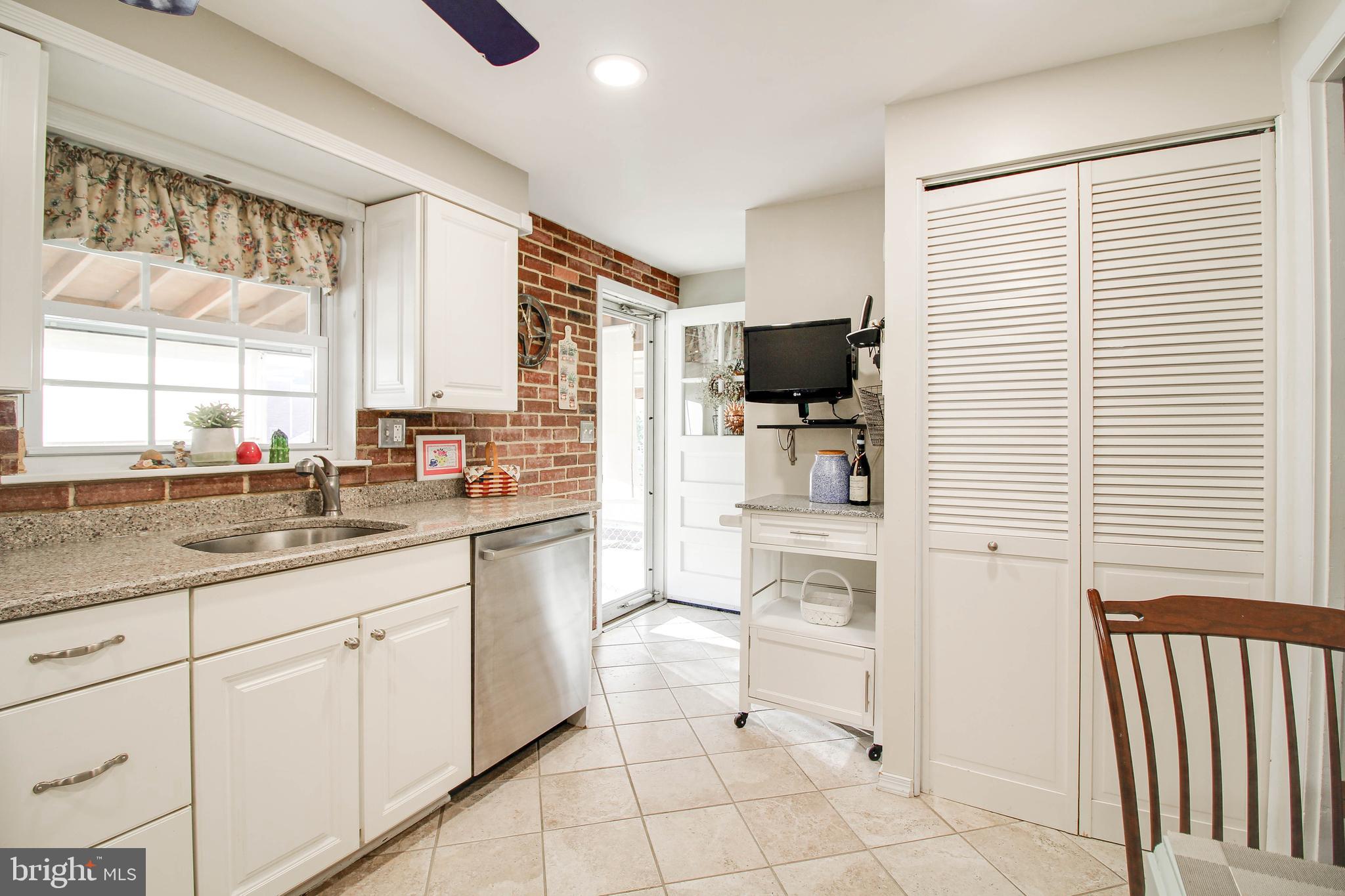 5649 Chelwynd Road Halethorpe, MD 21227 - Photo 12 of 44 a kitchen with white cabinets and white appliances