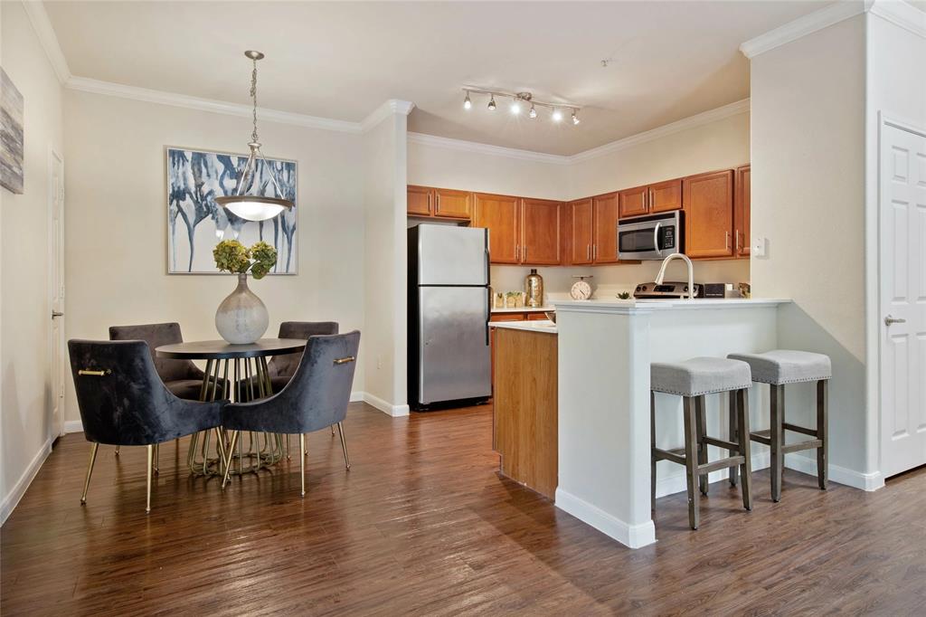 8800 Highway 290, Unit A1 627 Austin, TX 78736 - Photo 1 of 8 a dining room with furniture and wooden floor