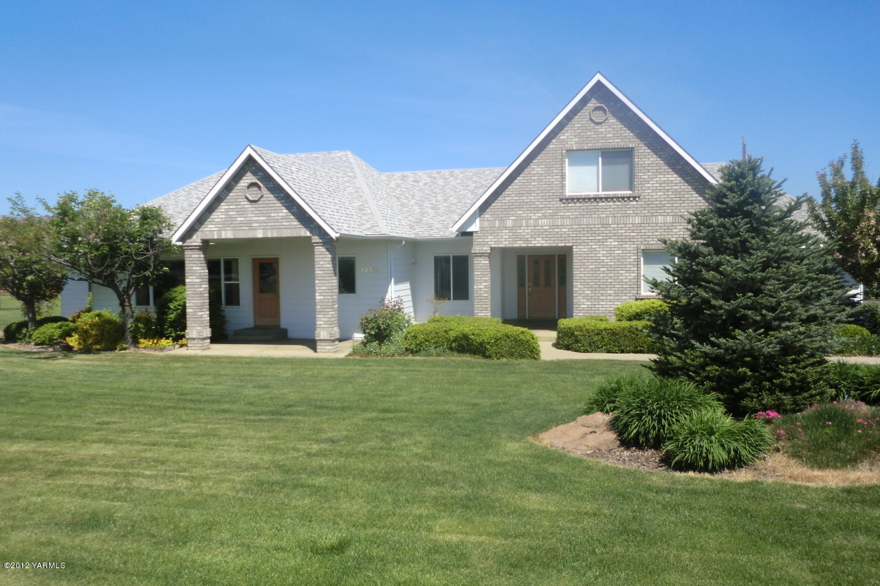12113 West Barrett Road Yakima, WA 98908 - Photo 1 of 36 a front view of a house with a yard and porch