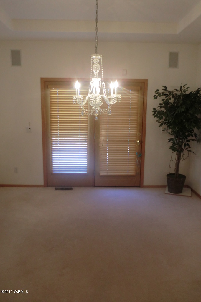 12113 West Barrett Road Yakima, WA 98908 - Photo 15 of 36 a view of a room with a chandelier fan and window