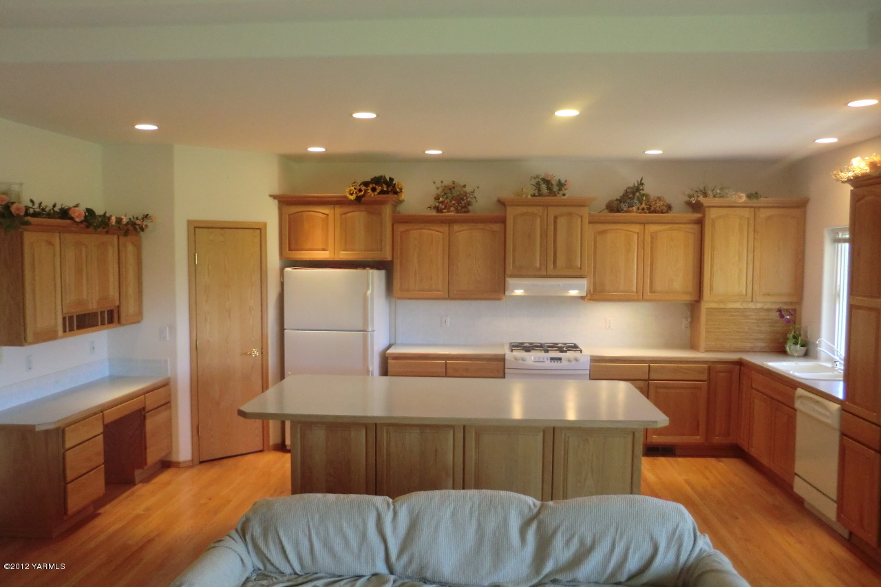 12113 West Barrett Road Yakima, WA 98908 - Photo 6 of 36 a kitchen with a refrigerator and a stove top oven