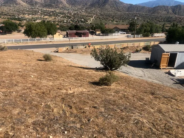a view of swimming pool with a yard and mountain view