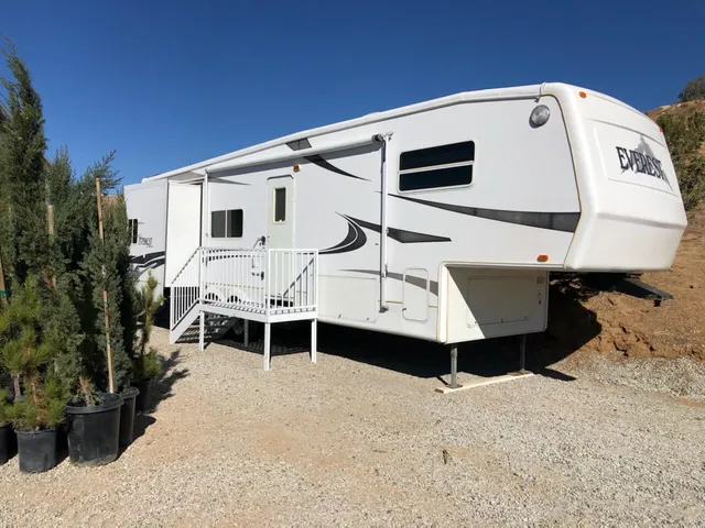 a white building with a large window and yard