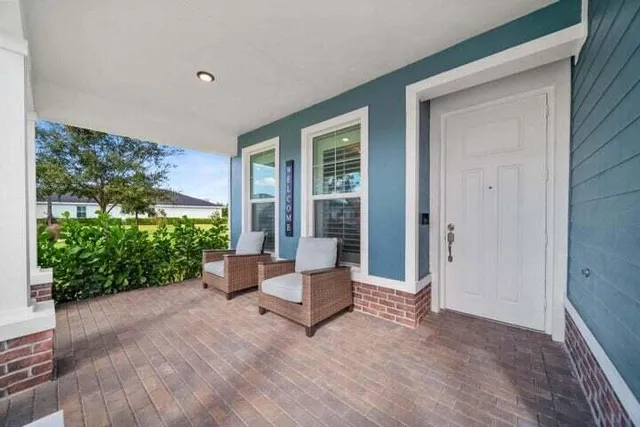 a building outdoor space with patio furniture and potted plants