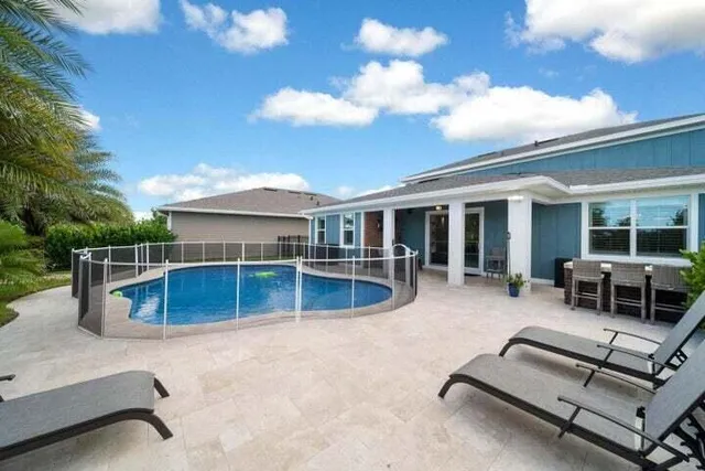swimming pool view with a outdoor seating space