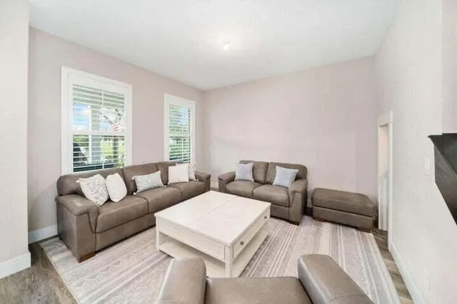 a living room with furniture and a large window