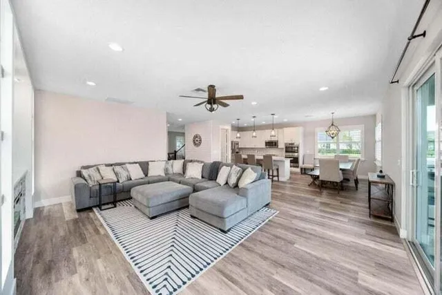 a living room with furniture and a chandelier