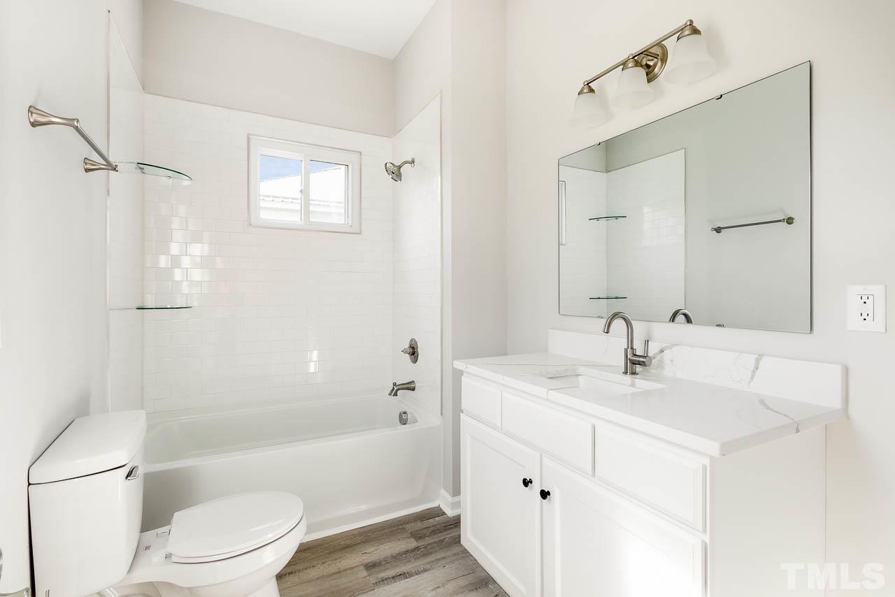 206 Edgar Street Roxboro, NC 27573 - Photo 17 of 18 a bathroom with a sink a toilet and shower