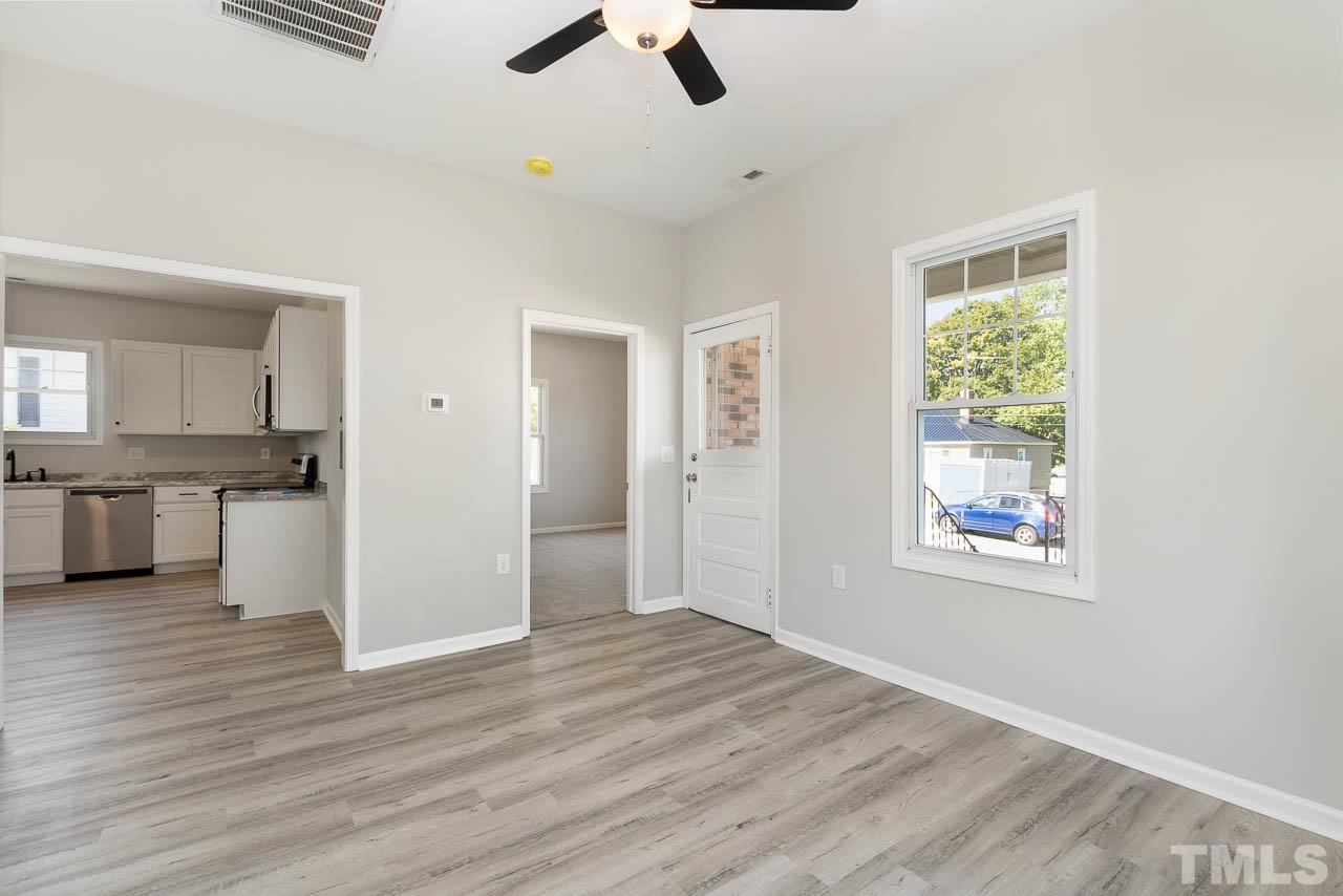 206 Edgar Street Roxboro, NC 27573 - Photo 4 of 18 a view of an empty room with window and wooden floor