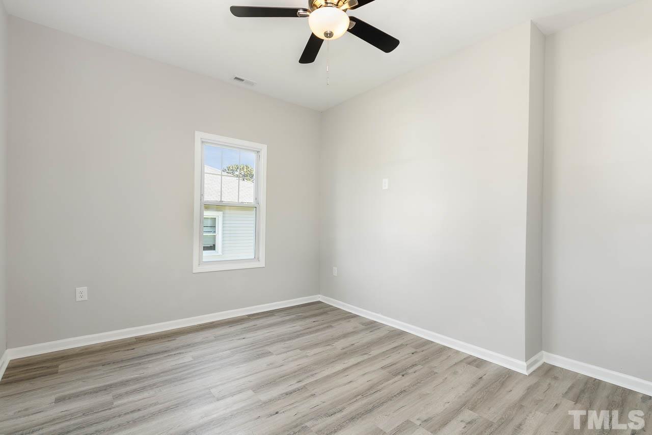 206 Edgar Street Roxboro, NC 27573 - Photo 9 of 18 wooden floor in an empty room with a window