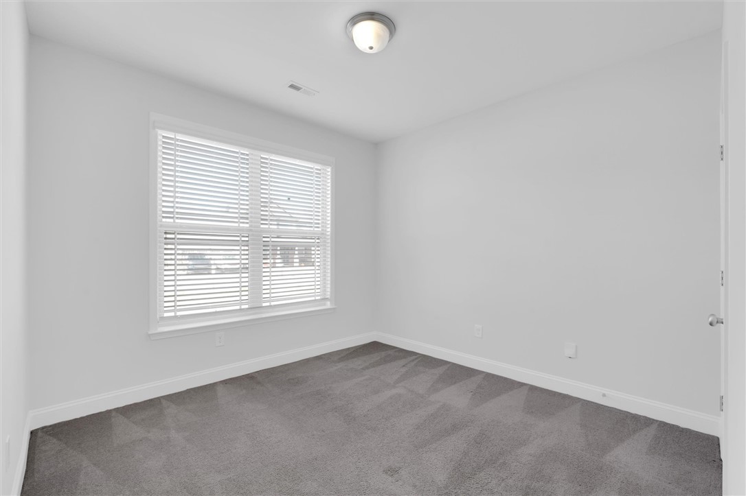 155 Norfolk Circle Anderson, SC 29625 - Photo 12 of 33 Bright and airy room with pristine walls and plush carpeting awaits your personal touch.