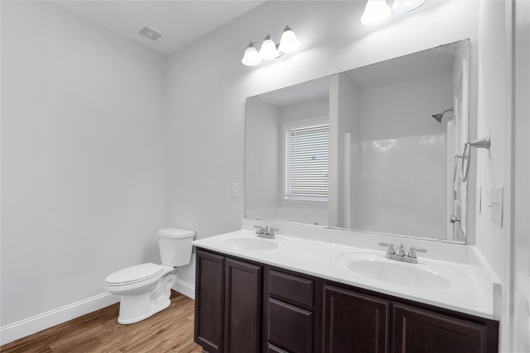 155 Norfolk Circle Anderson, SC 29625 - Photo 13 of 33 This bathroom offers dual vanities and a window for natural light.