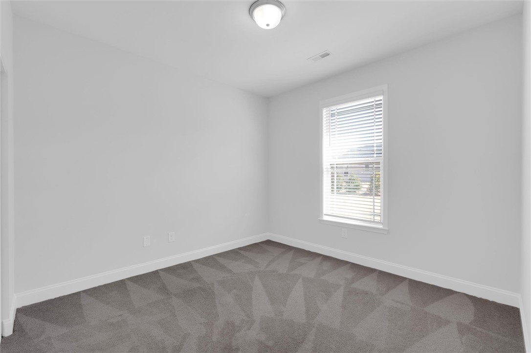 155 Norfolk Circle Anderson, SC 29625 - Photo 19 of 33 This spacious bedroom offers ample natural light and a clean, neutral palette.