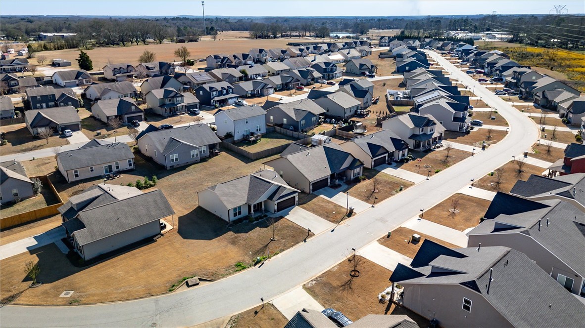 155 Norfolk Circle Anderson, SC 29625 - Photo 29 of 33 An aerial perspective reveals a winding street lined with homes in a vibrant community.