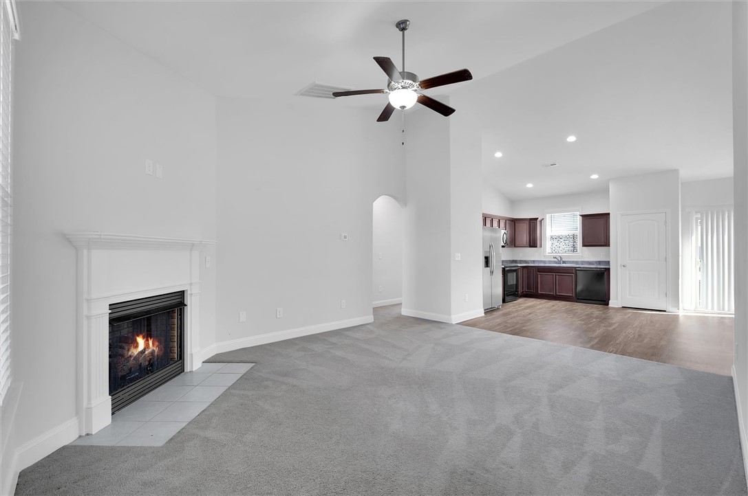 155 Norfolk Circle Anderson, SC 29625 - Photo 3 of 33 This living space features a cozy fireplace, vaulted ceilings, and an open layout connecting to the kitchen.