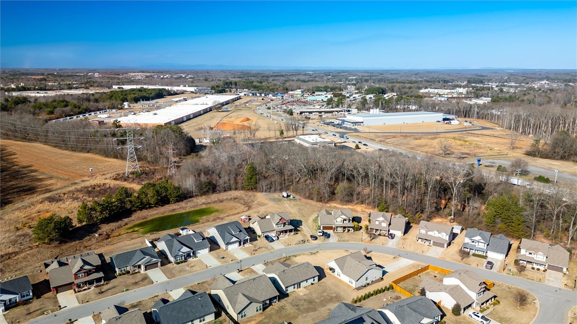 155 Norfolk Circle Anderson, SC 29625 - Photo 32 of 33 An aerial perspective showcases a residential neighborhood nestled amidst a sprawling, undeveloped landscape.