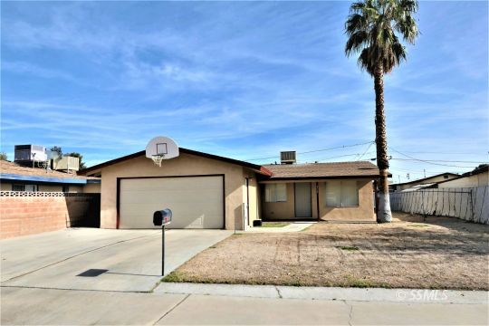214 South Fire Opal Street Ridgecrest, CA 93555 - Photo 1 of 29 a front view of a house with a yard and garage