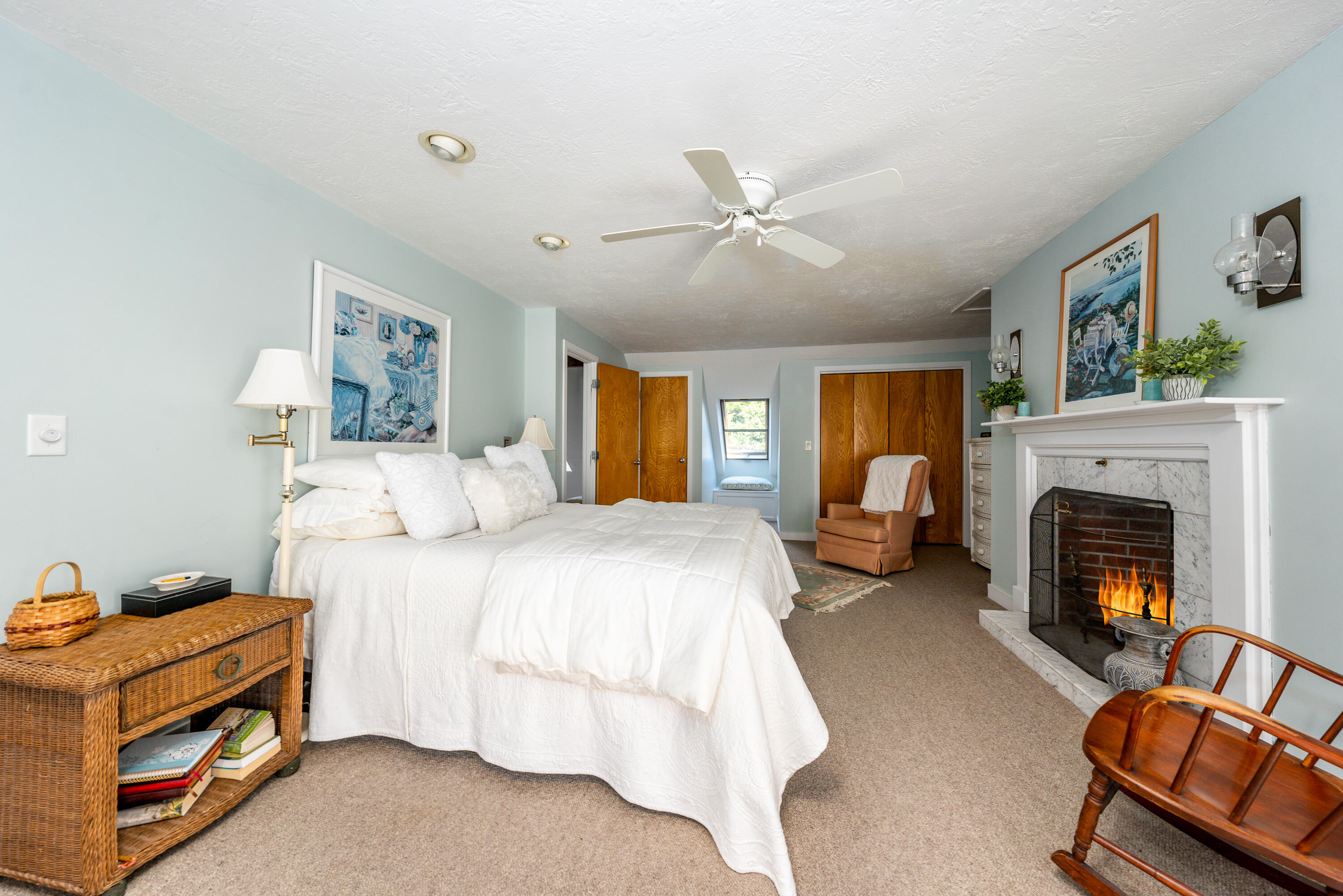 79 Waterside Drive Centerville, MA 02632 - Photo 23 of 50 a spacious bedroom with a bed and a fireplace