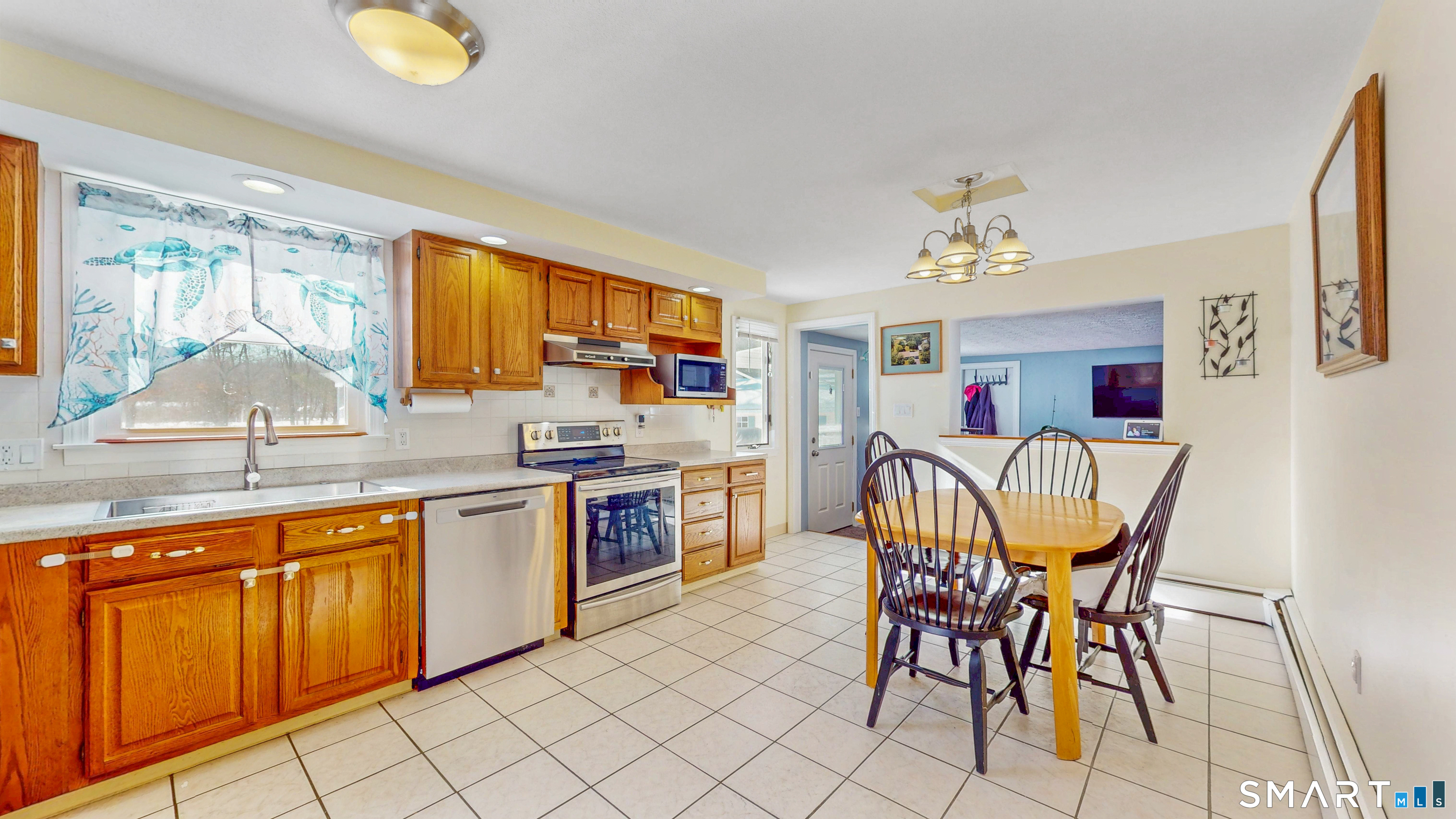 38 Eastgate Lane Enfield, CT 06082 - Photo 11 of 33 a kitchen with a table chairs sink and microwave