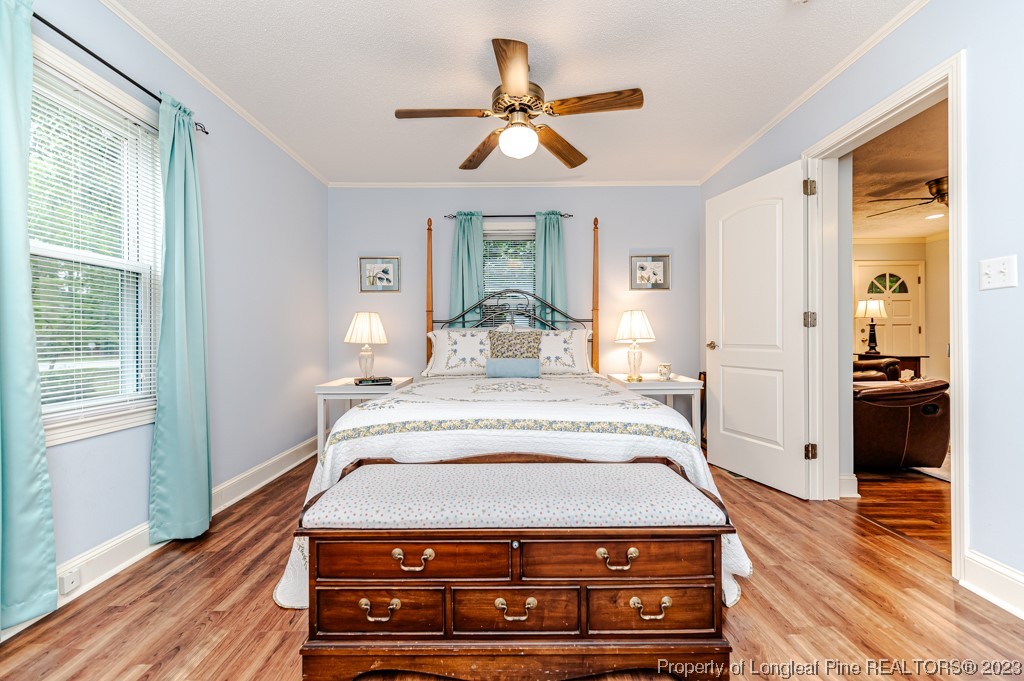 2411 Colon Road Sanford, NC 27330 - Photo 14 of 50 a bedroom with a bed and wooden floor