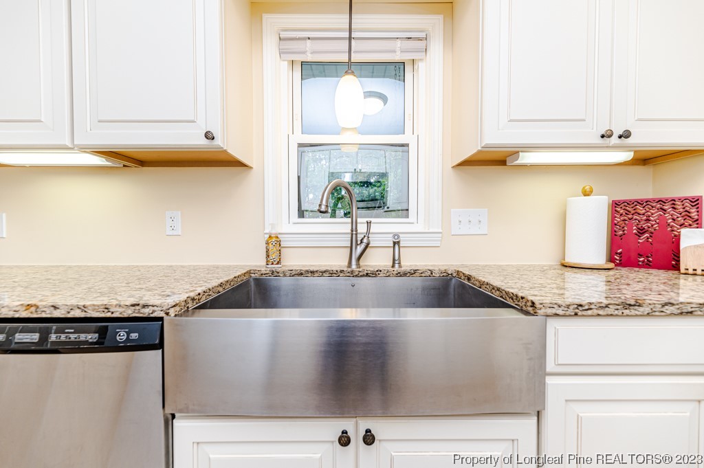 2411 Colon Road Sanford, NC 27330 - Photo 10 of 50 a kitchen with granite countertop a sink and a window
