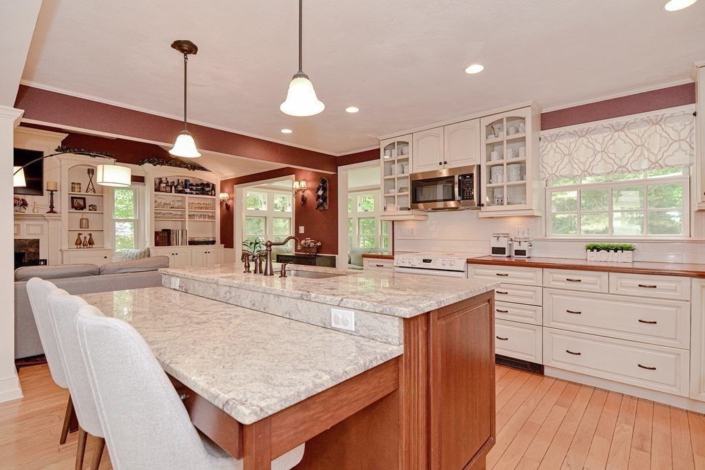1 Ivy Lane Ashland, MA 01721 - Photo 13 of 42 a large kitchen with kitchen island a large island in the center a sink a window and stainless steel appliances