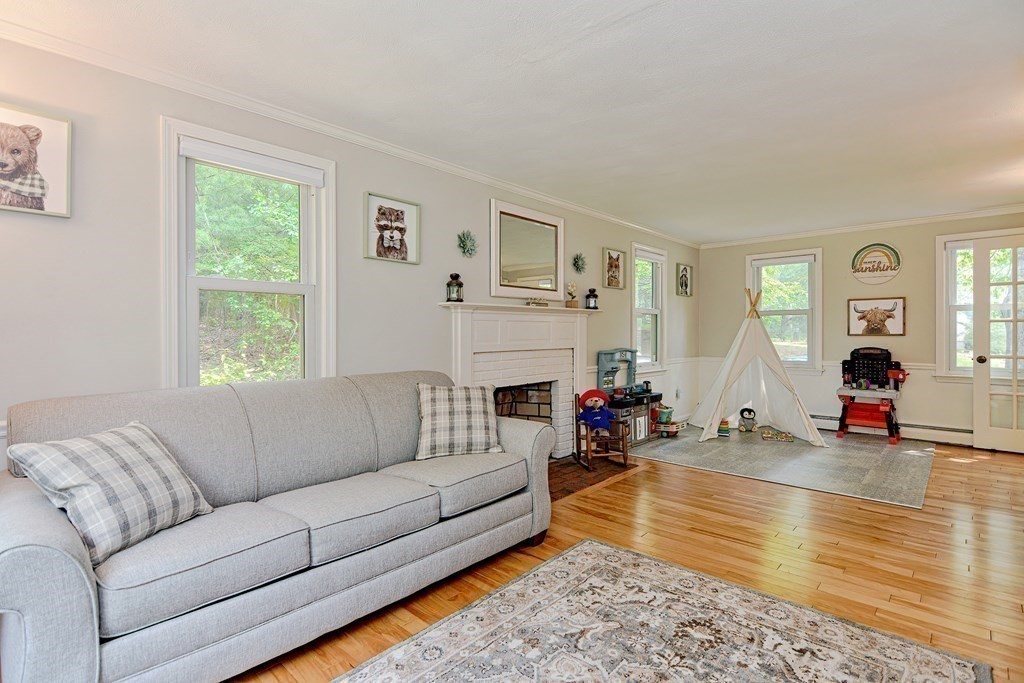 1 Ivy Lane Ashland, MA 01721 - Photo 21 of 42 a living room with furniture a fireplace and a table