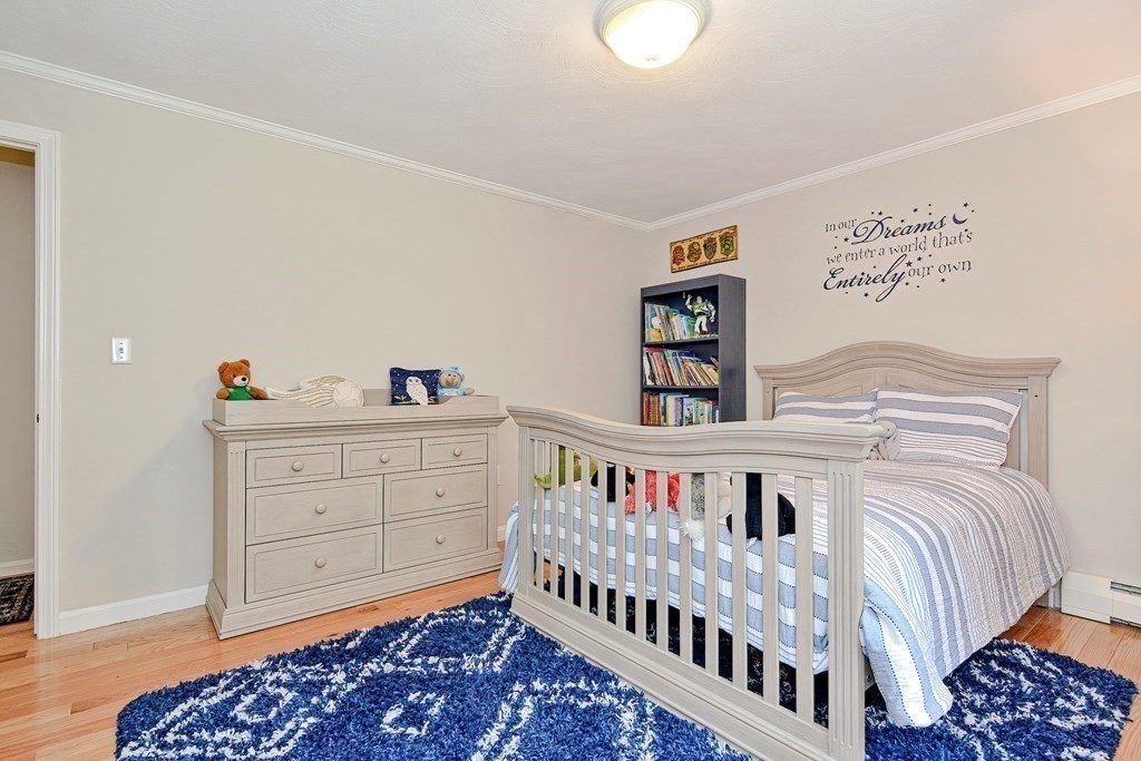 1 Ivy Lane Ashland, MA 01721 - Photo 23 of 42 a bedroom with a bed and baby crib