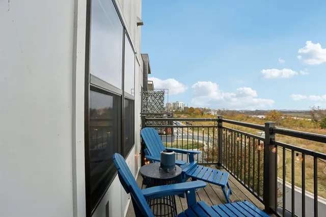 a view of balcony with a potted plant and wooden floor