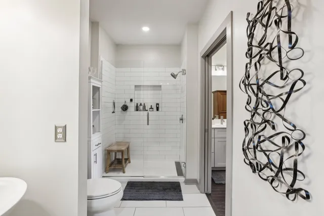 a bathroom with a toilet and a shower