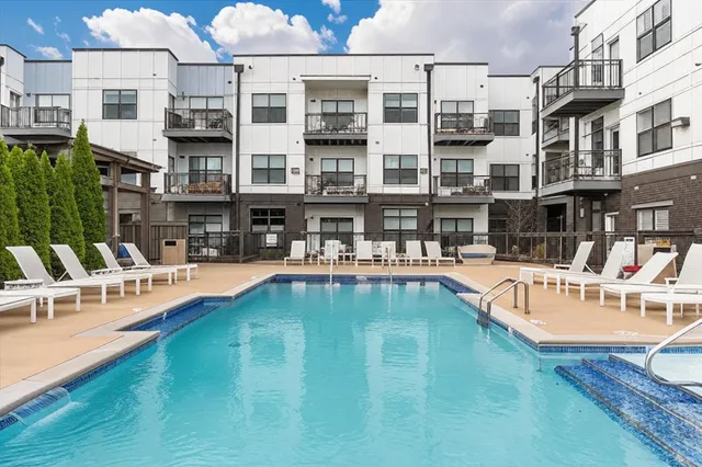 a swimming pool view with a outdoor seating