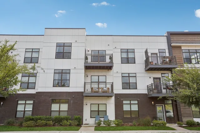 a front view of residential houses with yard