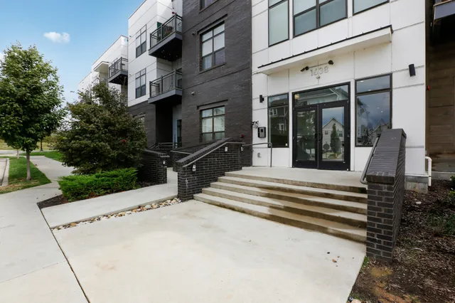 a view of a building with entryway and a yard