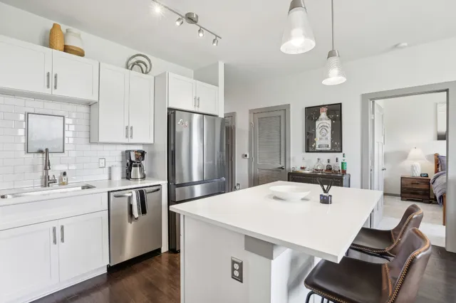 a kitchen with a sink stove and refrigerator