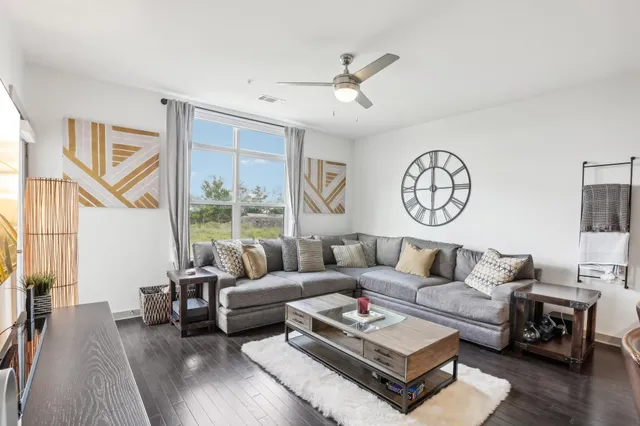 a living room with furniture and a large window