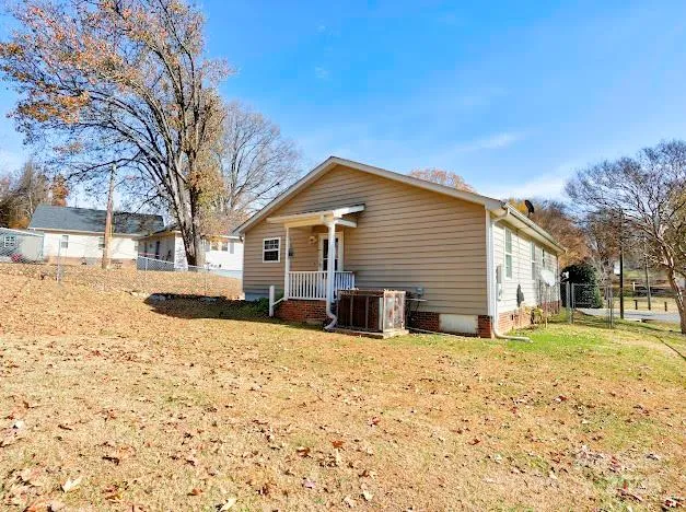 a front view of a house with a yard covered in snow