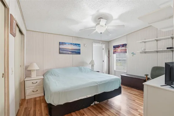 a bedroom with a bed and a flat screen tv