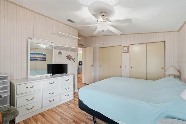 a large bedroom with a bed and a flat screen tv