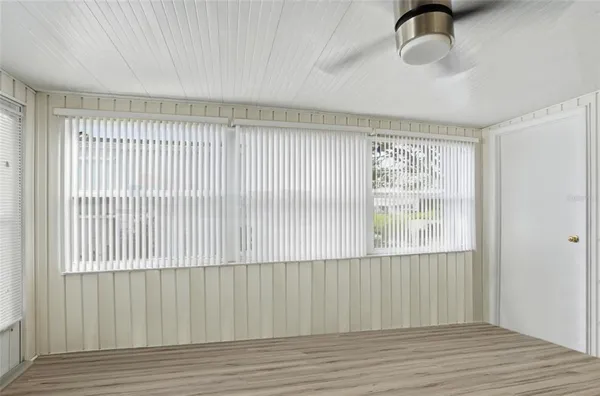 a view of a livingroom with wooden floor and a window