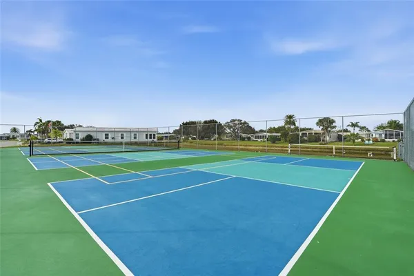a view of swimming pool with outdoor seating and lake view