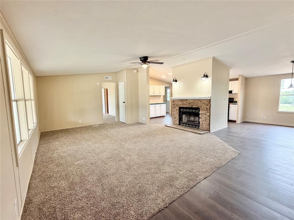 9721 Limestone Joshua, TX 76058 - Photo 9 of 36 an empty room with furniture and a fireplace