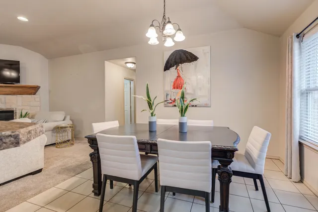 a view of a dining room with furniture and chandelier
