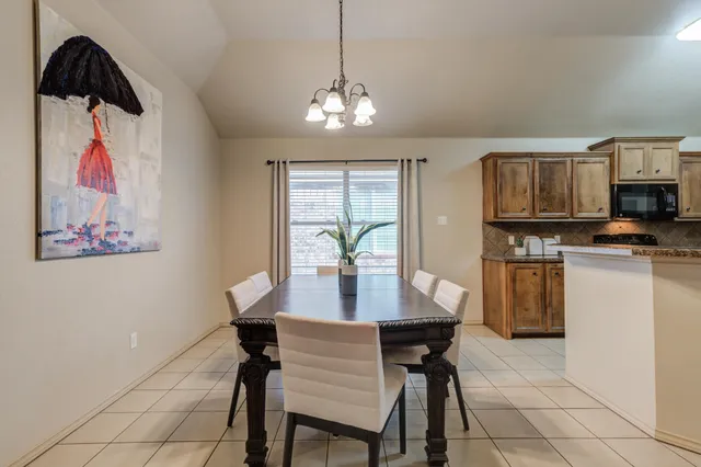 a view of a dining room with furniture and chandelier