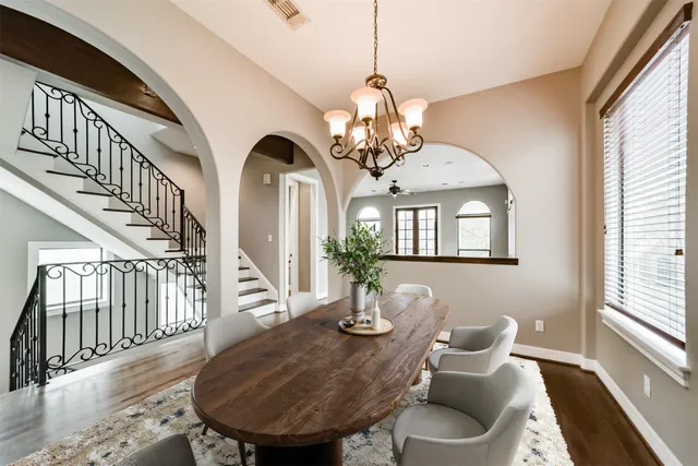 a view of a dining room with furniture wooden floor and chandelier