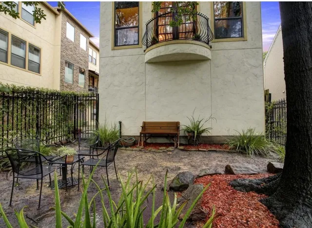 a view of a patio with table and chairs and potted plants