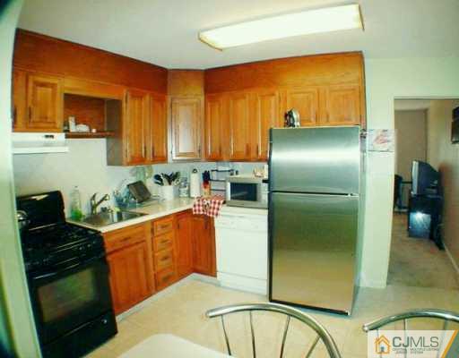 22 Caldwell Road Edison, NJ 08817 - Photo 3 of 8 a kitchen with stainless steel appliances granite countertop a refrigerator and a stove top oven