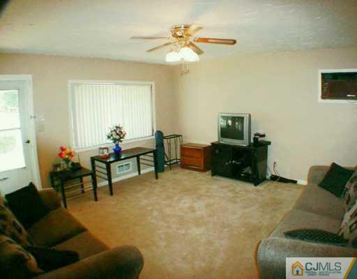 22 Caldwell Road Edison, NJ 08817 - Photo 5 of 8 a living room with furniture and a chandelier