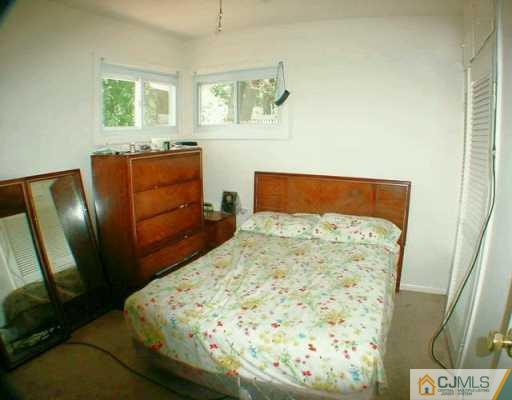 22 Caldwell Road Edison, NJ 08817 - Photo 7 of 8 a bedroom with a bed and wooden floor