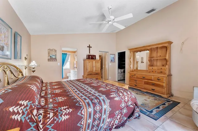 a bedroom with a bed and dresser