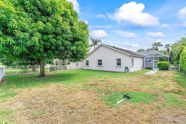 a view of a backyard with a garden and trees